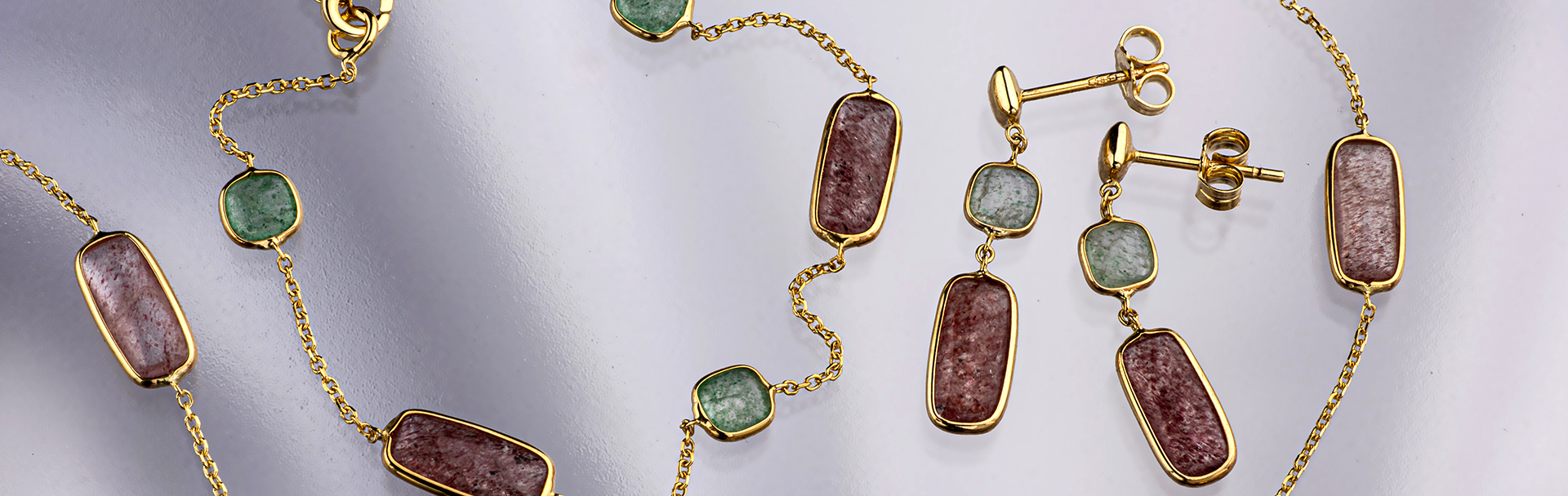 תכשיטי זהב 14 קראט בשיבוץ אבני טנזורין ירוקות וורודות